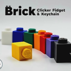 May include: A collection of Brick Clicker Fidget & Keychain items in white, blue, green, orange, red, purple, yellow, and black. Each rectangular block features a circular stud with the LEGO logo, and the black unit includes a metal keyring attachment.