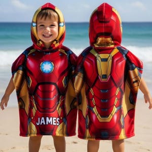 May include: A red, yellow, and gold hooded beach towel with an Iron Man design. The towel features a blue glowing circle on the chest and the name "JAMES" printed on the front. The towel is designed to resemble the Iron Man suit.