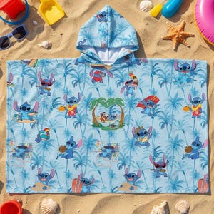 May include: A light blue hooded poncho towel featuring an all-over print of the character Stitch in various beach activities, including surfing and relaxing in a hammock, set against a background of palm trees and tropical foliage.