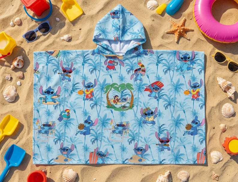 May include: A light blue hooded poncho towel featuring an all-over print of the character Stitch in various beach activities, including surfing and relaxing in a hammock, set against a background of palm trees and tropical foliage.