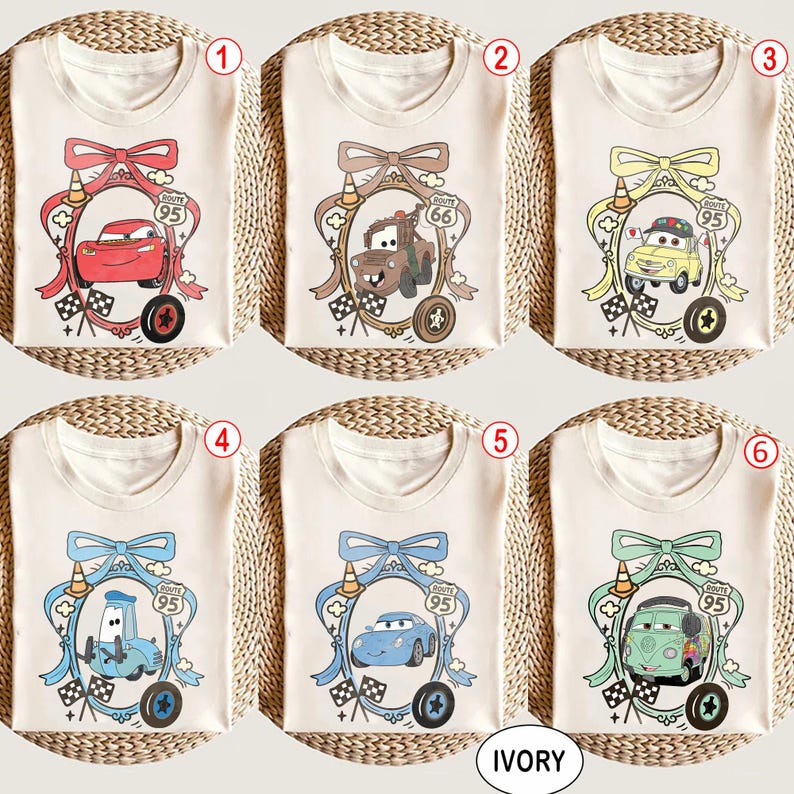 May include: Ivory-colored t-shirts featuring cartoon car designs within decorative frames. Each shirt showcases a different car character, with details like Route 95 signage, checkered flags, and bow accents. The word "IVORY" is printed at the bottom.