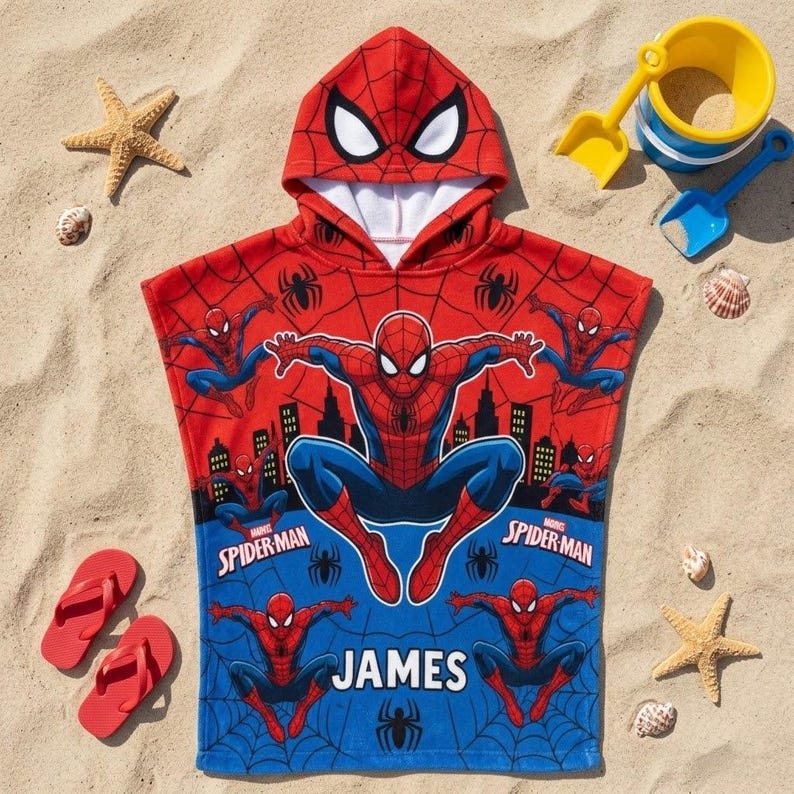 May include: A red and blue hooded towel featuring a Spider-Man graphic print, a web pattern, and the name James in white text. The hood includes a Spider-Man mask design with white eyes. The towel displays multiple action poses of the character.