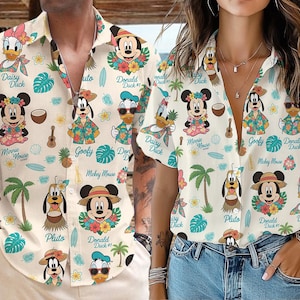 May include: Two short-sleeved button-down shirts with a cream background featuring cartoon characters like Mickey Mouse, Minnie Mouse, Donald Duck, and Goofy. The shirts have a tropical theme with palm trees, flowers, and surfboards.