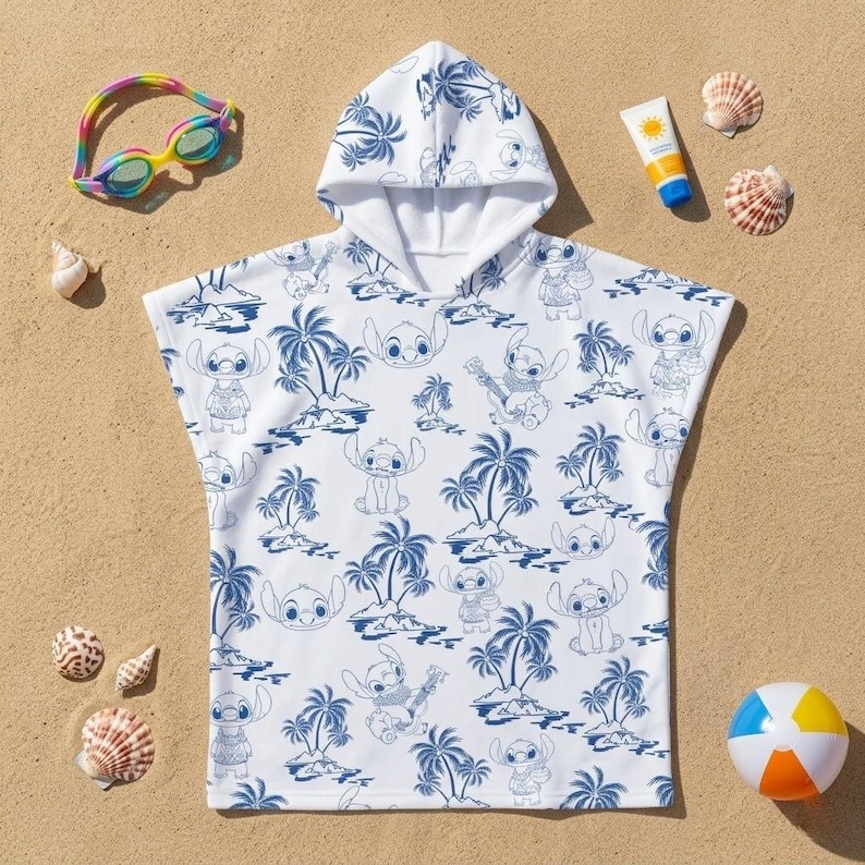 May include: A white hooded poncho towel featuring a repeating blue line art pattern of the character Stitch from Lilo & Stitch, interspersed with palm trees and tropical island motifs. The garment has short sleeves and a hood.