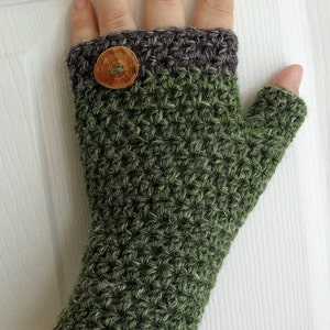 May include: Green and grey crochet fingerless gloves with a wooden button. CROCHET PATTERN text is at the top of the image.
