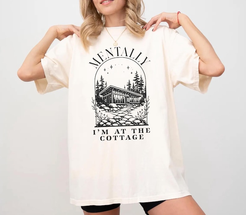 Unisex graphic shirt with mentally im at the cottage text inspired by hockey romance books, designed for booktok readers and lgbt sports romance fans.