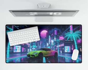 May include: A computer desk mat featuring a vibrant neon cityscape with a gradient sports car. A white keyboard and mouse are positioned on the mat. The scene includes palm trees and Japanese text.