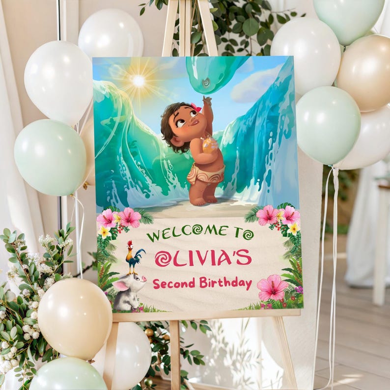 A Baby Moana welcome sign displayed on a wooden easel surrounded by balloons and greenery, reading "Welcome to Olivia’s Second Birthday".