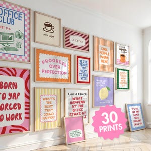 May include: A collection of thirty framed wall art prints featuring various office-themed slogans and colorful graphic designs. The prints display phrases like 'Office Club', 'Progress Over Perfection', and 'Cool People Work Here' in diverse fonts and patterns.