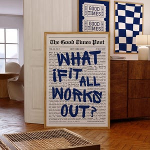 May include: A framed vertical poster featuring a newspaper design titled The Good Times Post with the bold blue handwritten text WHAT IF IT ALL WORKS OUT? overlaid on the center. The poster is displayed in a room with wooden flooring.