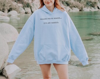 May include: A light blue hoodie with the text "Falling for no reason... It's my cardio." printed on the front.