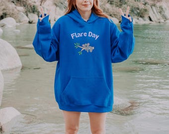 May include: A royal blue hoodie with a white graphic of two koalas on a branch. The text "Flare Day" is printed in white above the koalas.