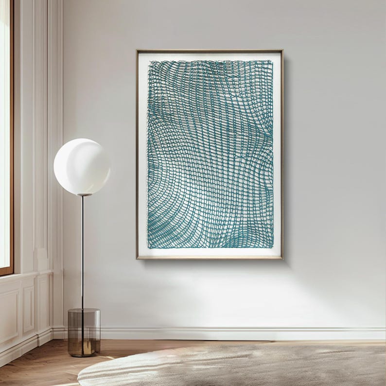 May include: Abstract teal artwork in a gold frame. The artwork features a woven pattern with curved lines, creating a textured effect. The piece is displayed on a white wall, adding a modern touch to the room's decor.