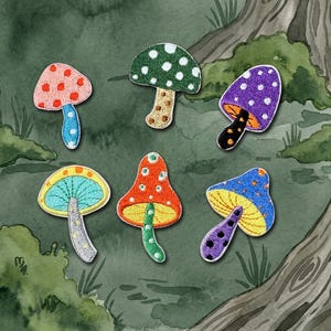 Puede incluir: Parches bordados de setas en varios colores, incluyendo rosa, verde, morado, naranja, azul y amarillo. Cada parche presenta un diseño único con lunares y costuras detalladas. Los parches están sobre un fondo de acuarela.