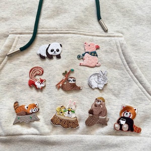 May include: A white ceramic mug with a black handle and the text "But First, Coffee" in a bold, black font. The mug is sitting on a wooden surface. The mug is approximately 4 inches tall.