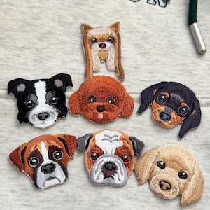 May include: Embroidered patches featuring various dog breeds, including a black and white Border Collie, a brown Poodle, and a tan Bulldog. The patches are detailed with realistic features and colors, perfect for adding to clothing or accessories.