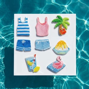 May include: Embroidered patches with summer designs. Includes a blue and white striped vest top, pink vest top, palm tree with crab, blue shorts, denim shorts, shaved ice, a drink with lemon, and a flamingo on a towel.