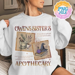 May include: White sweatshirt with a vintage-style apothecary design. The design includes the text "OWENS SISTER'S APOTHECARY" with illustrations of a mortar and pestle, a witch's hat, and a potion bottle. The text also includes the phrases "Always throw spilt salt over your left shoulder" and "keep rosemary by your garden gate, plant lavender for luck, and fall in love whenever you can."