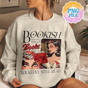 May include: Cream-colored sweatshirt featuring a graphic with the text "BOOKISH burning through Books WICKEDLY WELL READ." The graphic includes a retro illustration of a woman with devil horns and a stack of books.