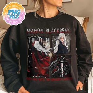May include: Black sweatshirt with a graphic print of a woman with white hair and a red cape, a dragon, and the text "Manon Blackbeak We are the Thirteen From now until the darkness claims us".