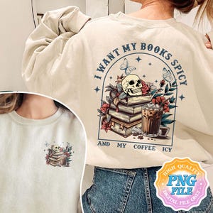 May include: A beige sweatshirt with a graphic design featuring a skull, books, coffee, and the text "I want my books spicy and my coffee icy".