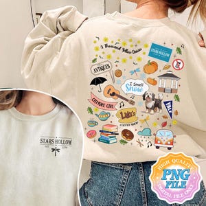 May include: A beige sweatshirt with a graphic print of various illustrations related to the TV show Gilmore Girls. The illustrations include a coffee cup, a book stack, a guitar, a gazebo, a dragonfly, a van, and the text "Stars Hollow" and "I Smell Snow".