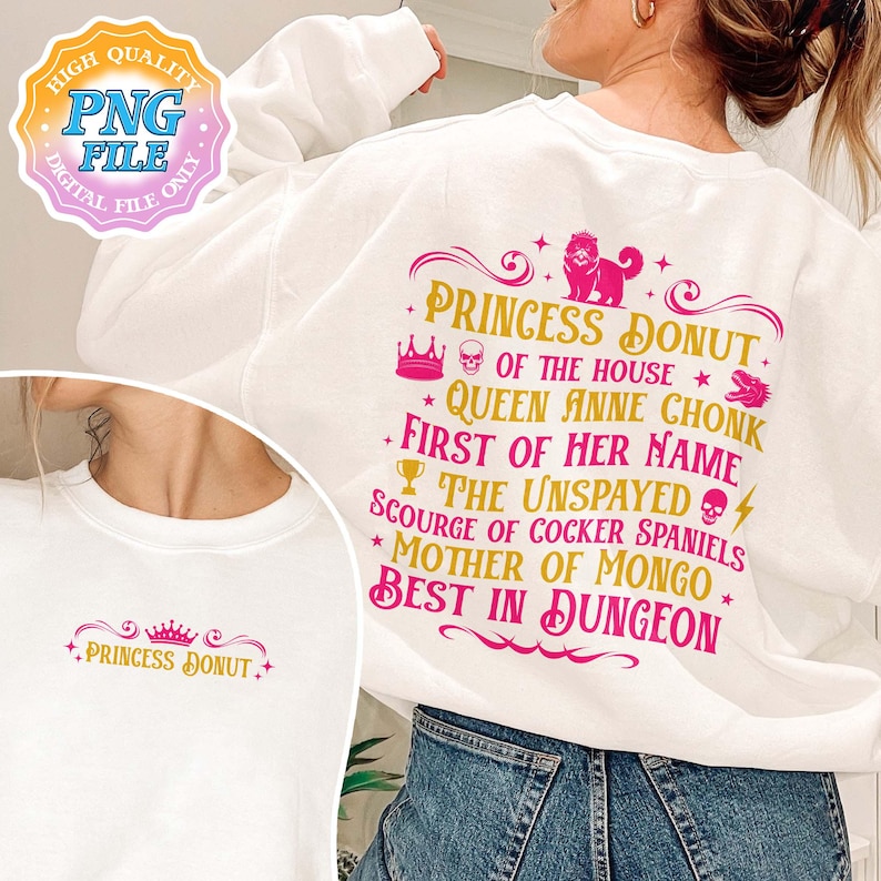 May include: White sweatshirt with a pink and gold graphic. The graphic reads "PRINCESS DONUT" and other phrases. A crown, skull, and dog are also featured in the design. The sweatshirt is a PNG file.