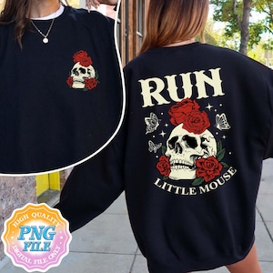 May include: Black sweatshirt with a skull and roses graphic and the text "Run Little Mouse" printed on the back.