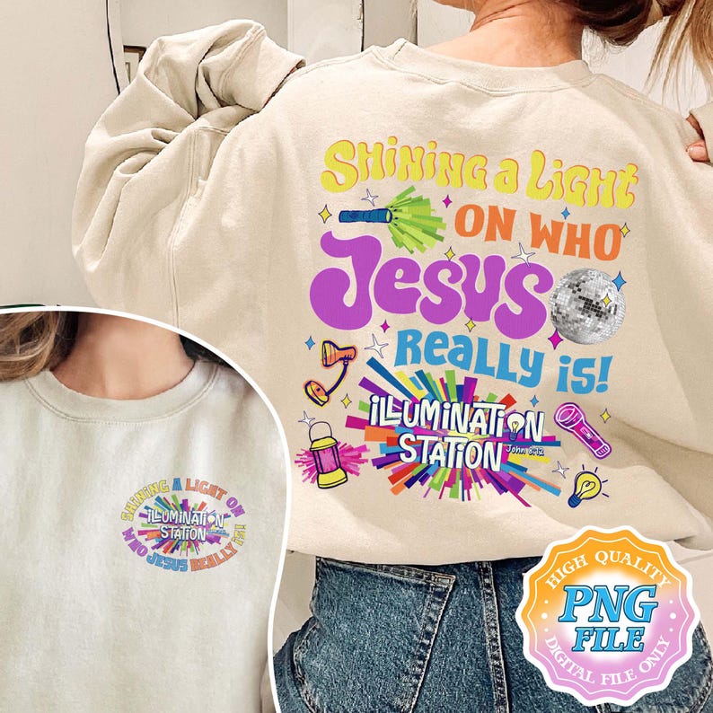 May include: Cream-colored sweatshirt with a colorful graphic on the back that reads "Shining a Light on Who Jesus Really Is!" with various illustrations. A smaller version of the design is on the front. The design includes the words "Illumination Station".