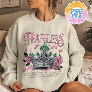 May include: A cream colored sweatshirt with the word "FEARLESS" in pink letters and a silver crown with green gems and pink roses. The text below the crown reads "I would spend the rest of my days making her flower crowns if she wanted to be my queen. My queen. Not Kitt's. Not Ilya's. Mine."