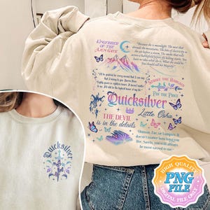 May include: A beige sweatshirt with a graphic design featuring a wolf, butterflies, and the text "Quicksilver, The Devil is in the details, Strike the Bargain, Pay the Price, Little Osha". The text "Because she is moonlight. The mist that shrouds the mountains. The bite of electricity in the air before a storm. The smoke that rolls across a battlefield before the killing starts. You have no idea what she is. What she could be. You should call her Majesty." is also included in the design.