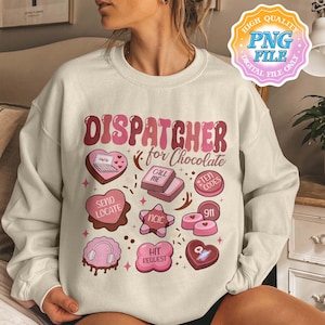 以下が含まれることがあります： ピンク色の「DISPATCHER for Chocolate」の文字が入ったクリーム色のスウェットシャツ。ハート型のノートパソコン、ヘッドフォン、電話など、ピンク色のチョコレートをテーマにした様々なグラフィックがデザインされています。スウェットシャツは長袖です。