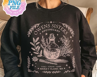 May include: A black long-sleeve sweatshirt featuring a light pink graphic print. The design displays a potion bottle, botanical elements, and the text "OWENS SISTERS APOTHECARY" along with "TONICS POTIONS ELIXIRS" and "MARIA'S ISLAND, MA" in a decorative frame.