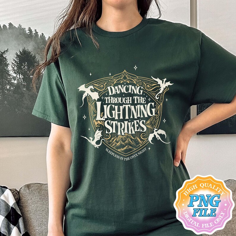 May include: Dark green t-shirt featuring a gold and white graphic with the text "Dancing Through The Lightning Strikes". The design includes dragons and the phrase "Sleepless in the Onyx Night". A digital PNG file is also available.