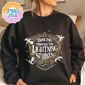 May include: Black sweatshirt with a gold and white graphic. The graphic reads "Dancing Through The Lightning Strikes" with dragon illustrations and the text "Sleepless in the Onyx Night".