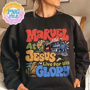 May include: Black sweatshirt with the words "MARVEL At JESUS Live For His GLORY" in a retro font. The design includes a train, desert landscape, and a cross. The sweatshirt has a vintage look.