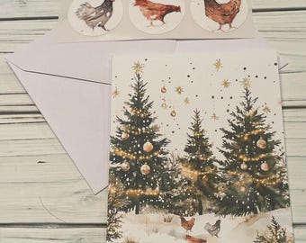 May include: A Christmas card with a watercolor illustration of snow-covered evergreen trees, gold ornaments, and chickens. Three round stickers with chicken illustrations and a white envelope are included.