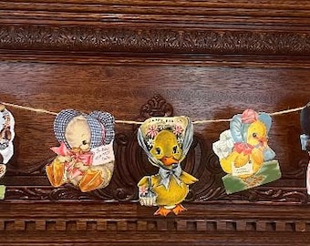 May include: A vintage Easter banner with a string of colorful paper cutouts featuring a bunny, chicks, and a cow. The banner is made of paper and has a rustic, vintage look.