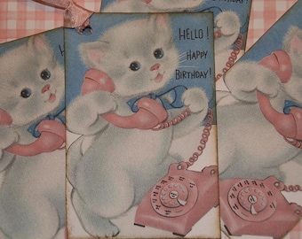 May include: Four vintage birthday cards featuring a white kitten holding a pink rotary phone with a blue background. The text on the card reads "Hello! Happy Birthday!"