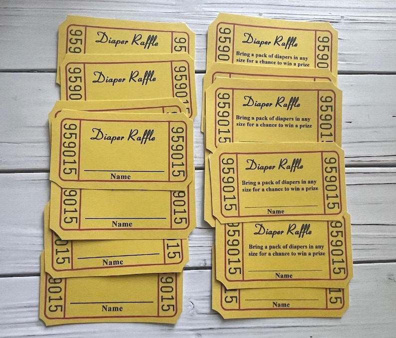 May include: A stack of yellow raffle tickets with red and black text. The tickets say "Diaper Raffle" and "Bring a pack of diapers in any size for a chance to win a prize". There is a blank line for a name on each ticket.
