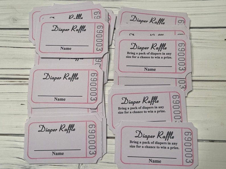 May include: A stack of pink and white raffle tickets with the text "Diaper Raffle" and "Bring a pack of diapers in any size for a chance to win a prize."  The tickets have a blank space for a name.