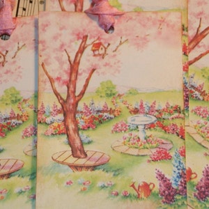 May include: Four vintage gift tags with a spring garden theme. Each tag features a pink flowering tree, a birdhouse, a small bird, and a bird bath. The tags are decorated with flowers and a watering can.