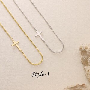 May include: Two delicate necklaces with a simple cross pendant. One necklace is gold and the other is silver. The necklaces are on a white background. The text "Style-1" is below the necklaces.