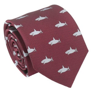 May include: A burgundy silk tie with a white shark pattern.