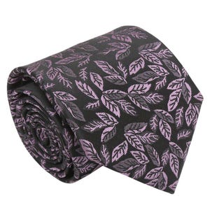 May include: Rolled black tie featuring a repeating pattern of lavender-coloured leaves. The tie is made of a smooth fabric, suitable for formal or business wear. The leaves have detailed veining.