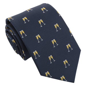 Può includere: Cravatta blu navy con un motivo ripetuto di calici di champagne gialli e bianchi. La cravatta è realizzata in tessuto strutturato, adatta alle occasioni formali. Un accessorio classico.