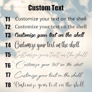 May include: Image featuring the text "Custom Text" in bold black font. Below, eight lines of text read "Customize your text on the shell" in various fonts, each labeled T1 through T8. The background is a soft, blurred gradient.