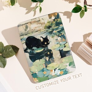 May include: A rectangular phone case featuring a black cat on lily pads in a pond. The design includes water lilies, a pond, and the text "Lily" in a script font. The bottom of the case reads "CUSTOMIZE YOUR TEXT".