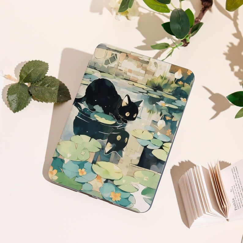 May include: A rectangular tablet case featuring a black cat with yellow eyes, reflected in water with lily pads. The artwork has a watercolor style with a soft color palette of blues, greens, and beige. The case is likely designed for a tablet or e-reader.
