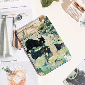 May include: Rectangular decorative panel featuring a black cat and a duck in a pond with lily pads. The artwork has a watercolor style with soft greens, blues, and yellows. The panel is on a white surface.